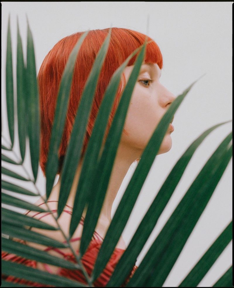 Transplanting, Pap Magazine Woman poses behind plant for Pap Magazine