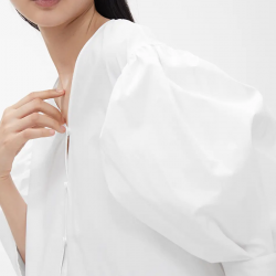 Model poses in white, wide dress Model poses in white, wide dress