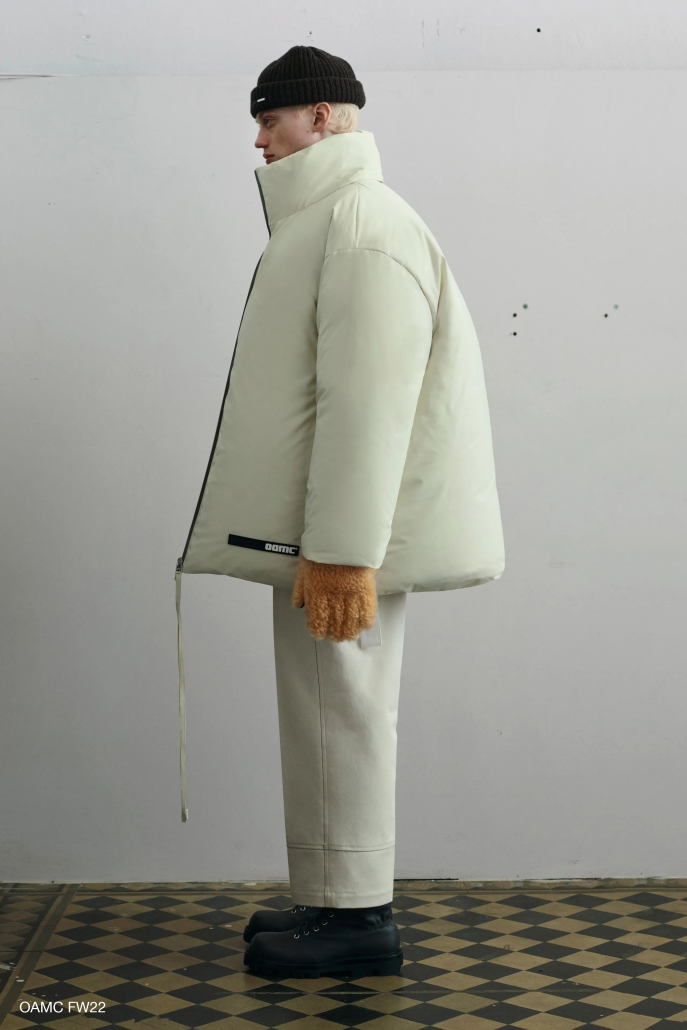 Model poses in white puffer jacket