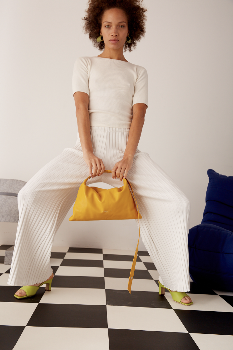 Jessie Cundiff Model poses with yellow bag